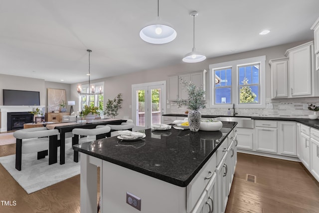 706 Fireball Ct, Knightdale, NC 27545 - kitchen with dark wood-style floors, backsplash, white cabinetry, and recessed lighting