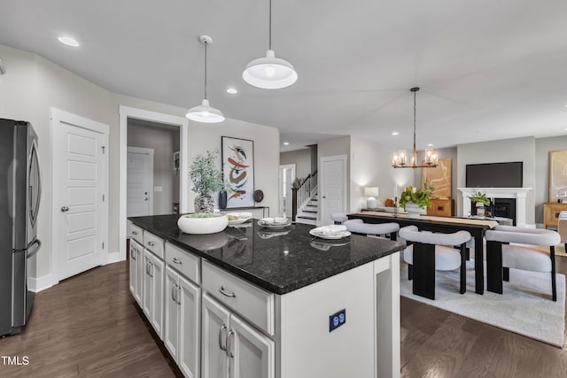 706 Fireball Ct, Knightdale, NC 27545 - kitchen with stainless steel fridge with ice dispenser, dark wood-style floors, white cabinetry, open floor plan, and recessed lighting