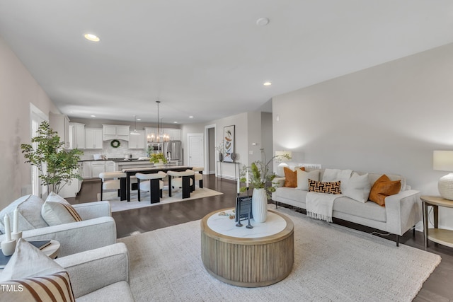 706 Fireball Ct, Knightdale, NC 27545 - living room with a chandelier, dark wood finished floors, recessed lighting, and baseboards
