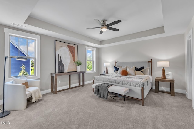 706 Fireball Ct, Knightdale, NC 27545 - carpeted bedroom with a tray ceiling, baseboards, and ceiling fan