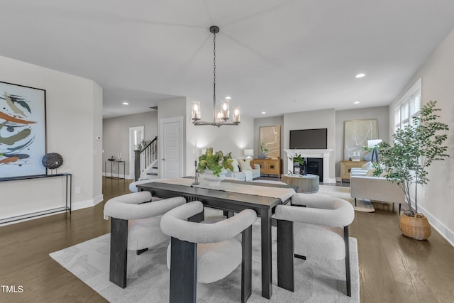 706 Fireball Ct, Knightdale, NC 27545 - dining space featuring wood finished floors, stairway, baseboards, a chandelier, and recessed lighting