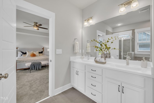 706 Fireball Ct, Knightdale, NC 27545 - ensuite bathroom with double vanity, a ceiling fan, a shower stall, tile patterned flooring, and baseboards
