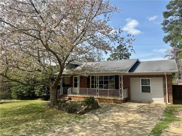 5704 Selkirk Pl, Fayetteville, NC 28304 - single story home featuring a shingled roof, covered porch, brick siding, a front lawn, and driveway