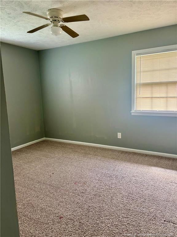 5704 Selkirk Pl, Fayetteville, NC 28304 - carpeted spare room with a textured ceiling, baseboards, and a ceiling fan