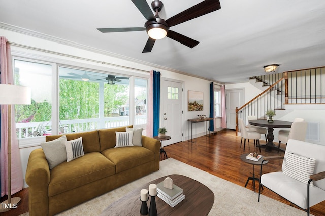 200 Lincoln Ct, Raleigh, NC 27610 - living room with wood finished floors, ceiling fan, stairs, and ornamental molding