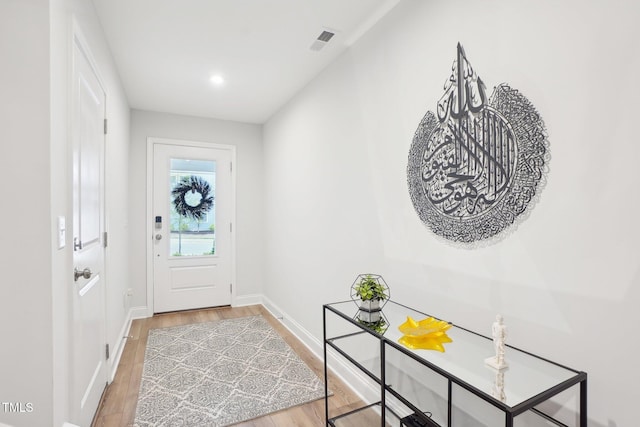 entryway with visible vents, baseboards, and light wood-style floors