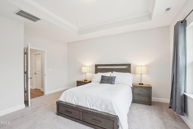 bedroom featuring visible vents, baseboards, a raised ceiling, and carpet floors