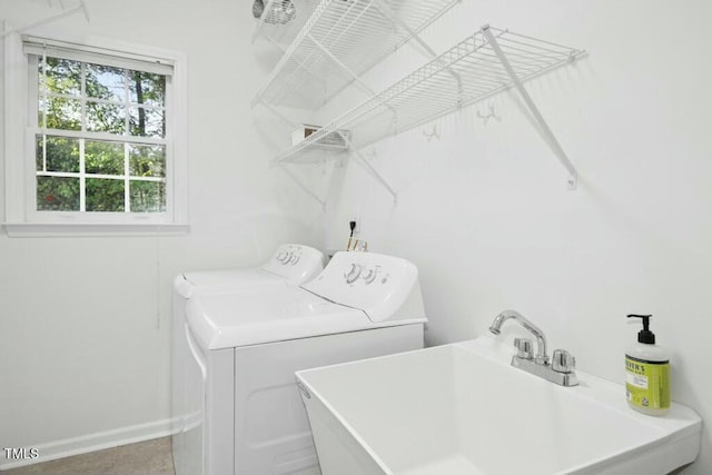 102 Cockleshell Ct, Cary, NC 27513 - washroom with a sink, baseboards, separate washer and dryer, and laundry area
