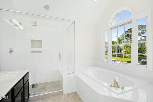 102 Cockleshell Ct, Cary, NC 27513 - bathroom featuring a shower stall, a garden tub, vanity, and vaulted ceiling