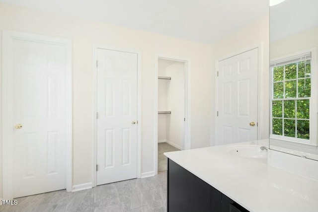 102 Cockleshell Ct, Cary, NC 27513 - full bathroom with baseboards, a walk in closet, and vanity