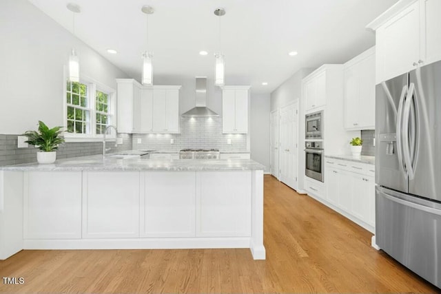 102 Cockleshell Ct, Cary, NC 27513 - kitchen featuring tasteful backsplash, a sink, wall chimney exhaust hood, and stainless steel appliances