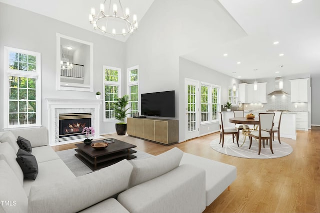 102 Cockleshell Ct, Cary, NC 27513 - living area featuring recessed lighting, an inviting chandelier, light wood-style floors, and a fireplace