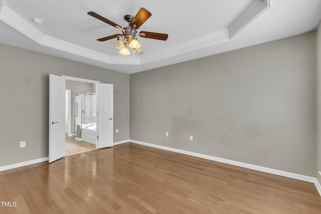 113 Dowington Ln, Cary, NC 27519 - unfurnished bedroom with a raised ceiling, wood finished floors, crown molding, baseboards, and ensuite bath