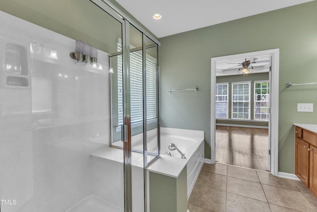 113 Dowington Ln, Cary, NC 27519 - full bathroom with vanity, a stall shower, a garden tub, a ceiling fan, and recessed lighting