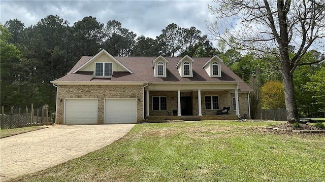cape cod-style house with driveway, an attached garage, a front yard, fence, and covered porch