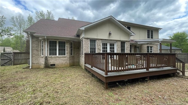 back of house with a wooden deck, crawl space, a yard, fence, and brick siding