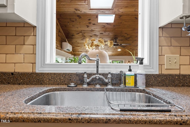 kitchen view of a sink and tasteful backsplash