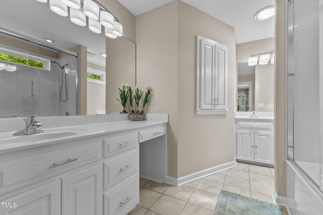 bathroom with a shower stall, tile patterned floors, vanity, and baseboards