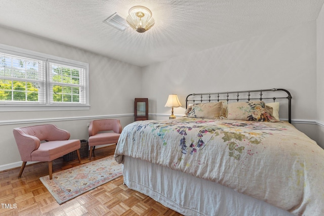 bedroom featuring a textured ceiling and baseboards