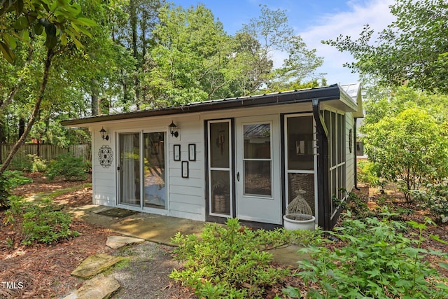 view of outbuilding featuring fence