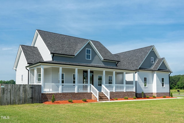 view of front facade featuring a shingled roof and a porch
