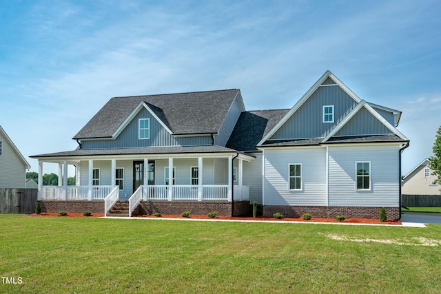 view of front of house featuring board and batten siding, covered porch, and roof with shingles