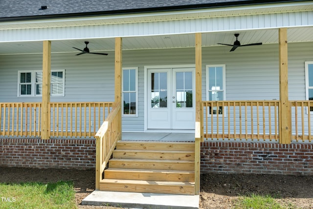 entrance to property with a ceiling fan, a porch, and a shingled roof