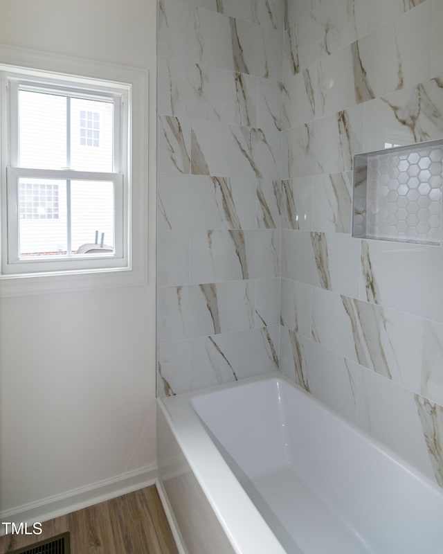 full bath with baseboards and wood finished floors