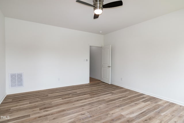 spare room with light wood-style flooring, ceiling fan, and baseboards