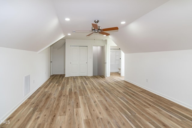 additional living space with lofted ceiling, light wood finished floors, recessed lighting, ceiling fan, and baseboards