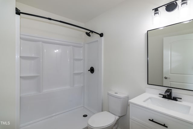 bathroom featuring a shower, vanity, and toilet