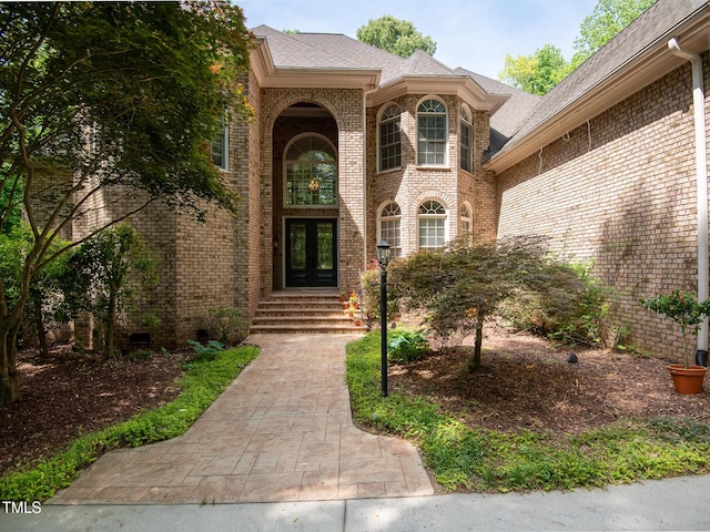 540 Vista Del Lago Ln, Wake Forest, NC 27587 - property entrance with french doors, brick siding, and a shingled roof