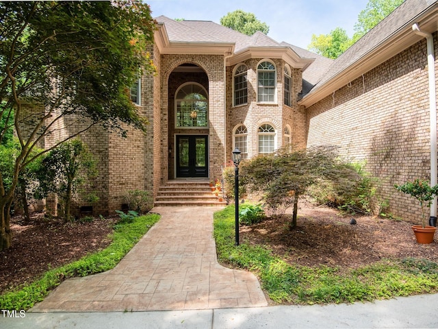 540 Vista Del Lago Ln, Wake Forest, NC 27587 - doorway to property featuring french doors, brick siding, and roof with shingles