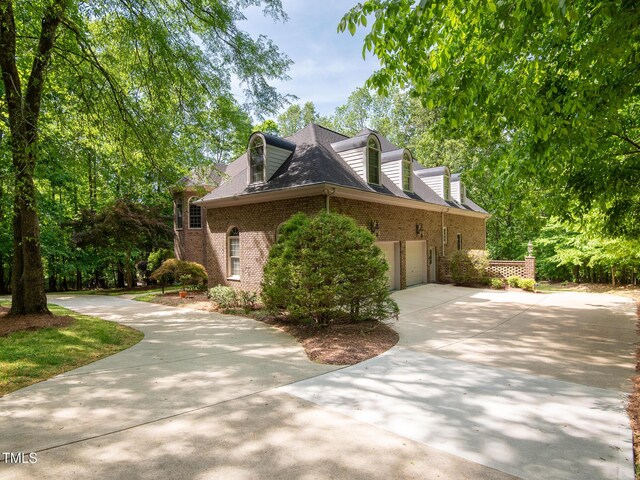 540 Vista Del Lago Ln, Wake Forest, NC 27587 - view of property exterior with concrete driveway, brick siding, and an attached garage