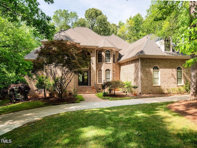 540 Vista Del Lago Ln, Wake Forest, NC 27587 - french provincial home featuring brick siding, a front lawn, and a shingled roof