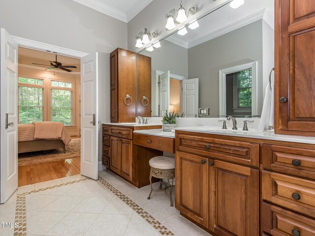 540 Vista Del Lago Ln, Wake Forest, NC 27587 - ensuite bathroom with crown molding, double vanity, tile patterned floors, a ceiling fan, and inlaid floor details