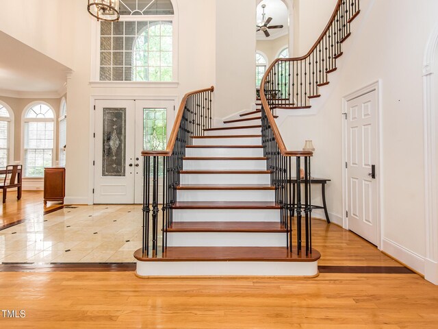 540 Vista Del Lago Ln, Wake Forest, NC 27587 - entrance foyer featuring a towering ceiling, stairs, ceiling fan, baseboards, and ornamental molding