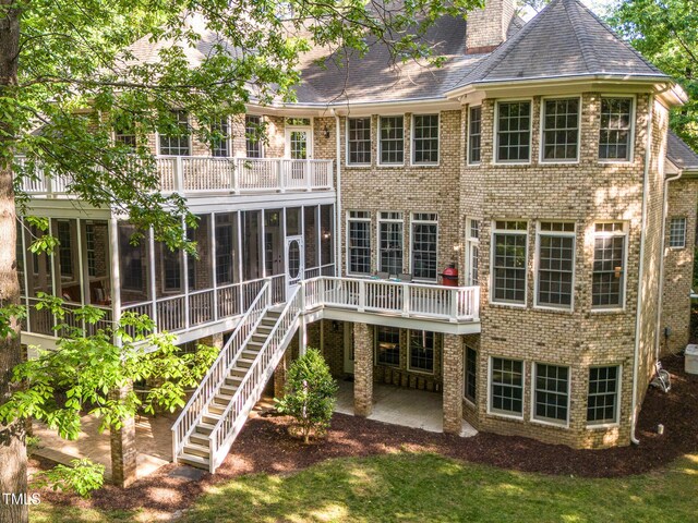540 Vista Del Lago Ln, Wake Forest, NC 27587 - back of house with a sunroom, a balcony, a patio area, and brick siding