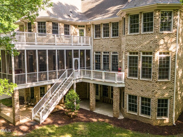 540 Vista Del Lago Ln, Wake Forest, NC 27587 - rear view of house with a sunroom, a patio, a balcony, and brick siding