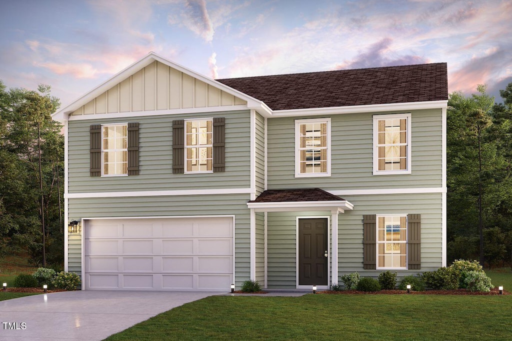 traditional home featuring concrete driveway, a front yard, board and batten siding, and an attached garage