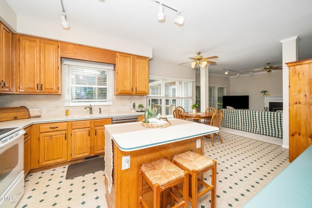kitchen with rail lighting, a ceiling fan, white electric range oven, and light countertops