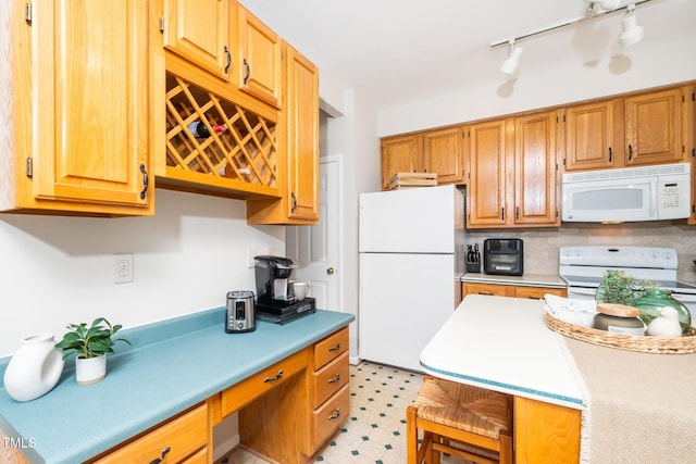 kitchen featuring white appliances, light countertops, tasteful backsplash, track lighting, and light floors