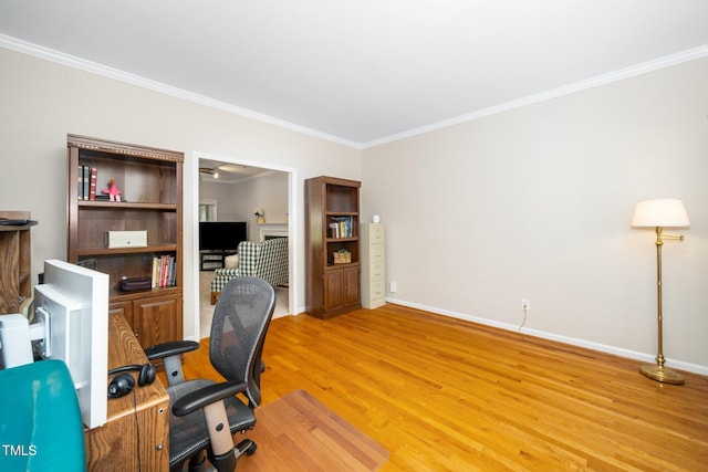 office space featuring ornamental molding, light wood finished floors, and baseboards
