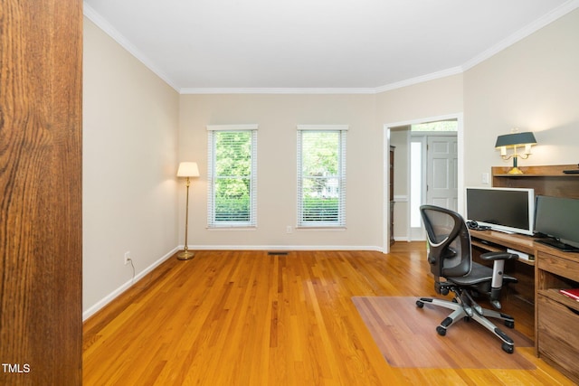 office featuring light wood-style flooring, baseboards, and crown molding
