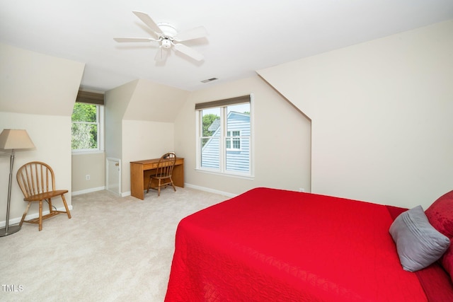 carpeted bedroom with vaulted ceiling, baseboards, and ceiling fan