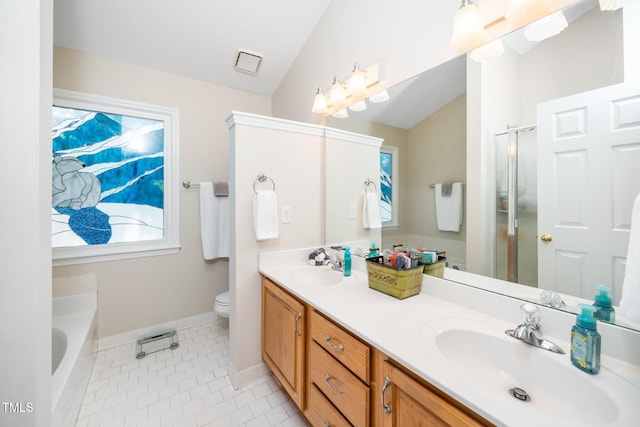 bathroom with baseboards, a stall shower, double vanity, toilet, and tile patterned floors