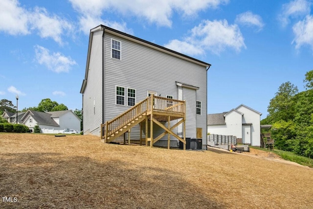 rear view of house with stairway and a deck