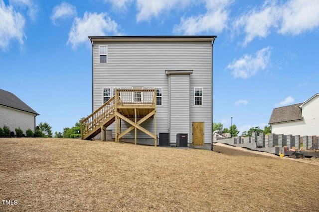 back of house with central air condition unit, a wooden deck, and stairway
