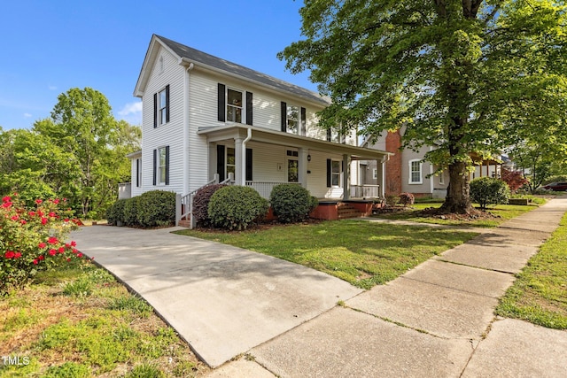 view of front of property with a front yard and covered porch