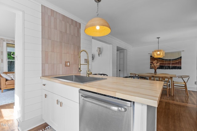 kitchen with dishwasher, a peninsula, a sink, and dark wood-style floors